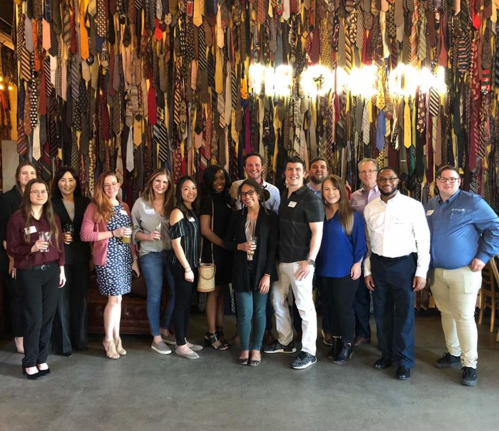 Group posing for photo at trade show event